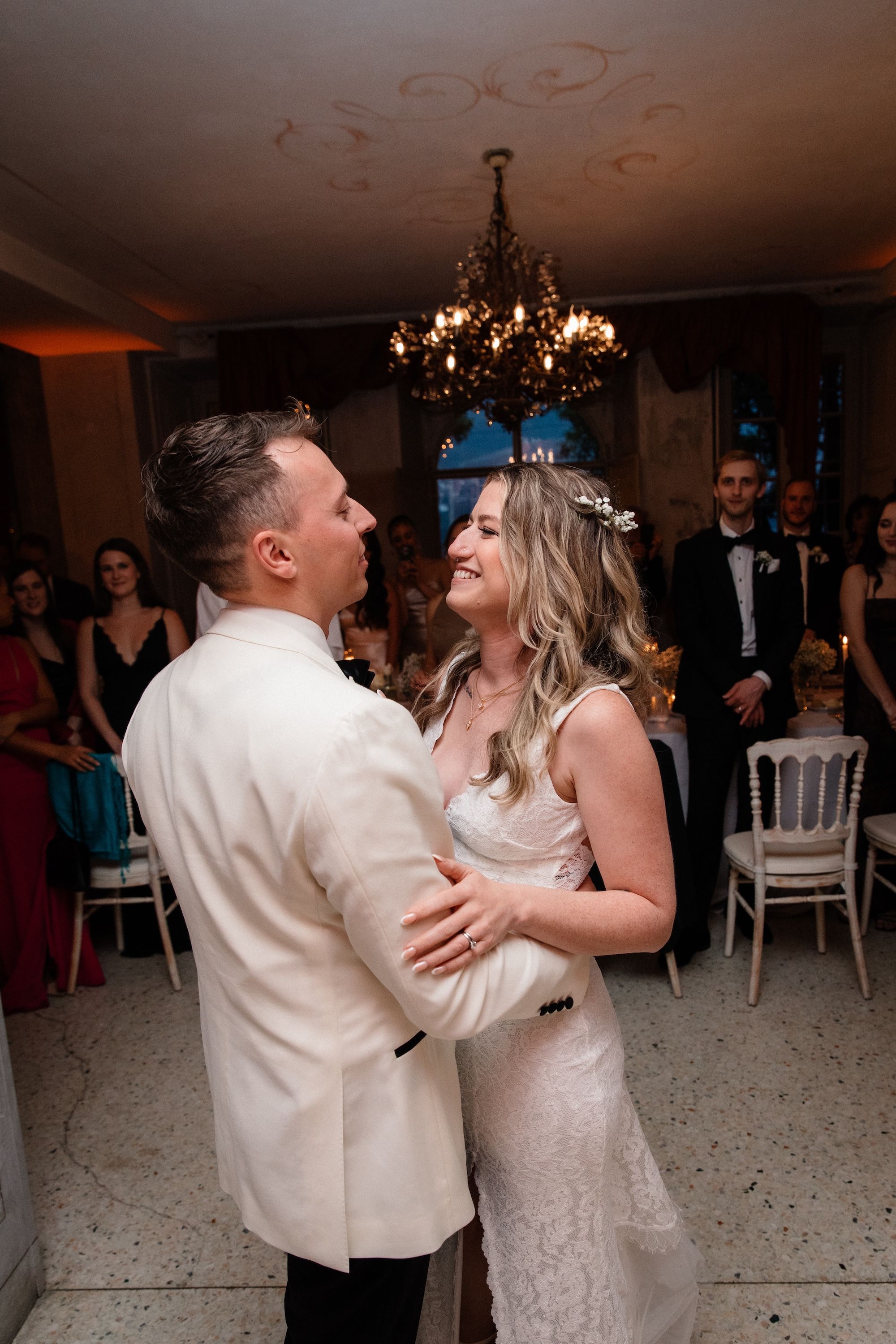 Newlyweds dance in front of their guests inside an event room of the hotel where they renewed vows in Italy