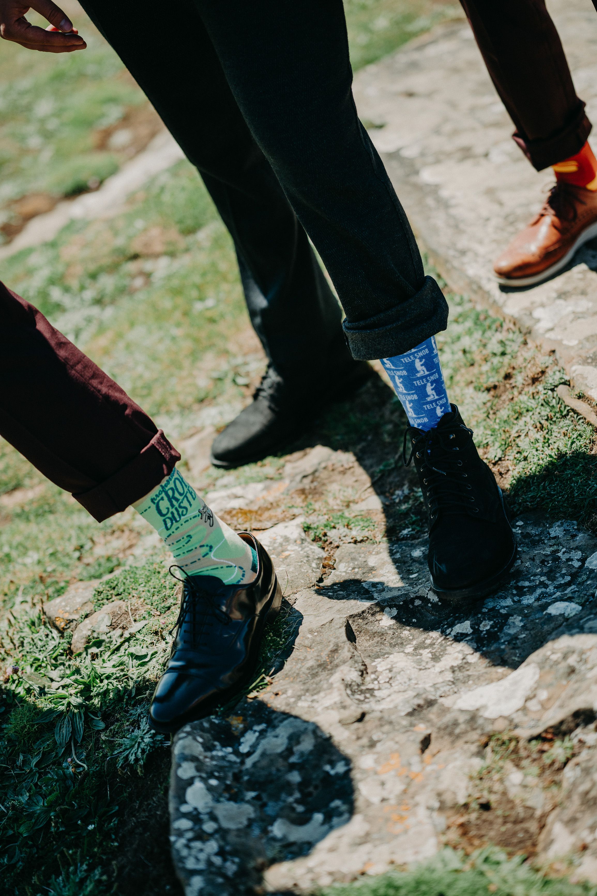 A groom and his groomsmen showing their socks before a small wedding in Ireland