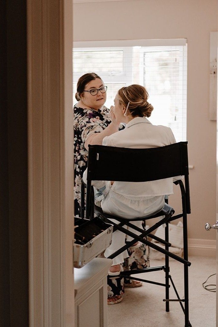 Destination wedding planner in Ireland, applying a bride's makeup