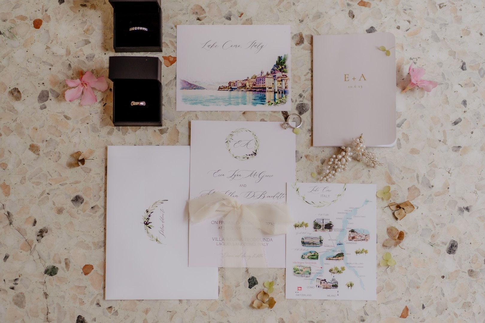 Flat lay of invitations and rings on a table for an Italian destination wedding