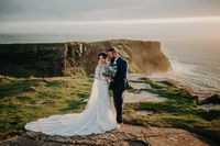 Bride and groom on their wedding day at the Cliffs of Moher in Ireland