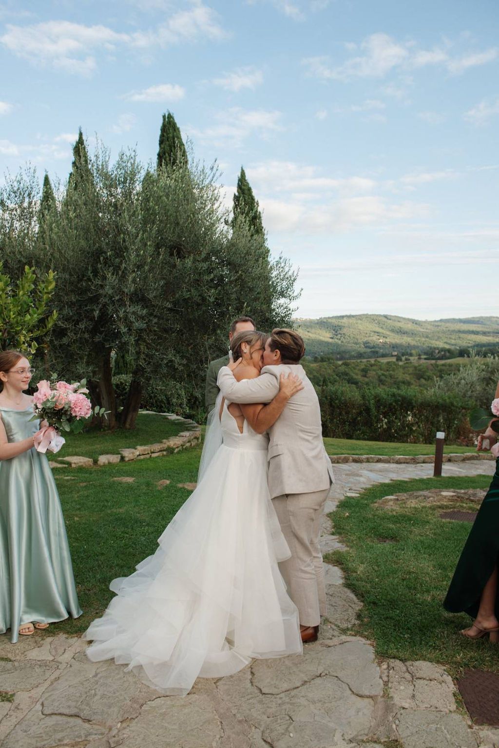 Newlyweds kissing during the outdoor ceremony in Tuscany for their small wedding in Italy