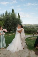 Newlyweds kissing during the outdoor ceremony in Tuscany for their small wedding in Italy