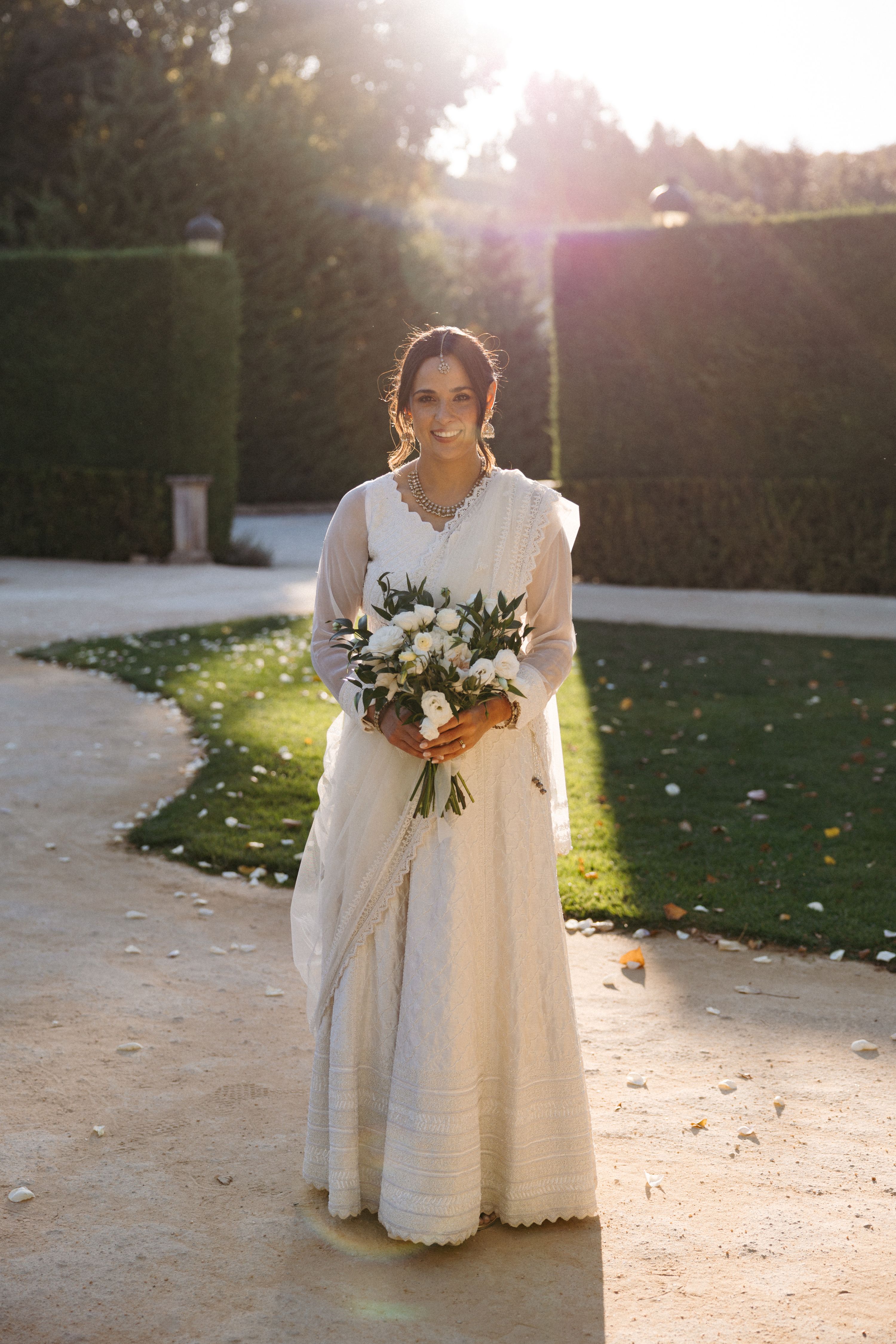 Bride holding a white bouquet during golden hour portraits at a small wedding in Portugal