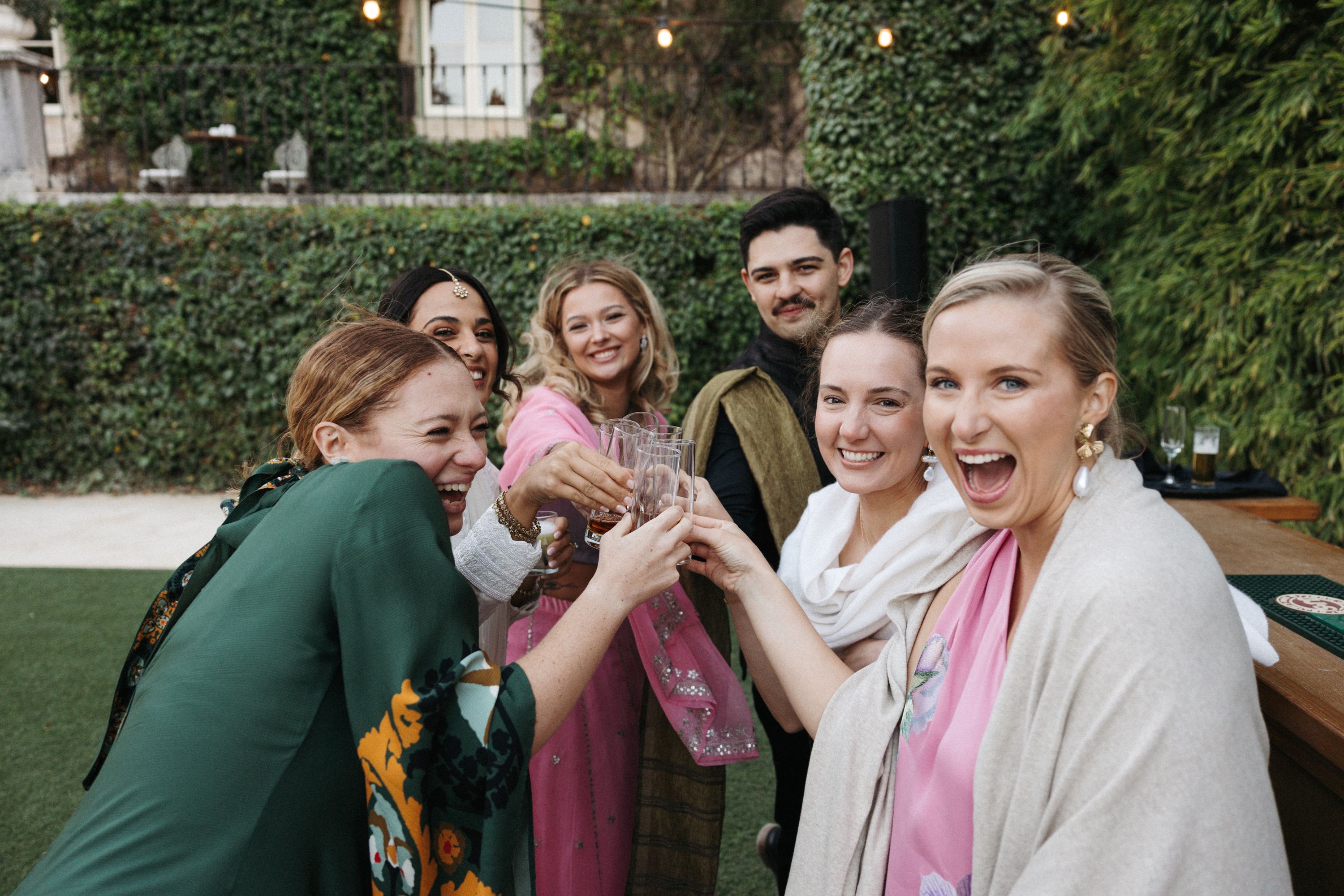 Wedding guests celebrating with a joyful toast at an intimate wedding in Portugal