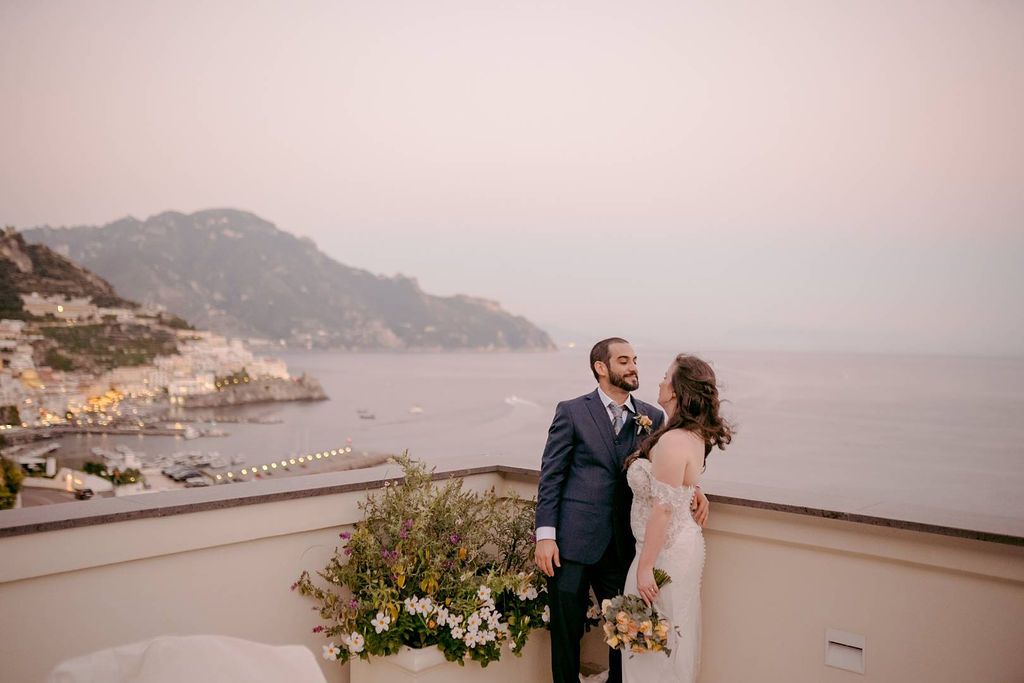 Bride and groom at the terrace of a hotel in Amalfi during their destination wedding in Italy