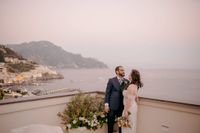 Bride and groom at the terrace of a hotel in Amalfi during their destination wedding in Italy