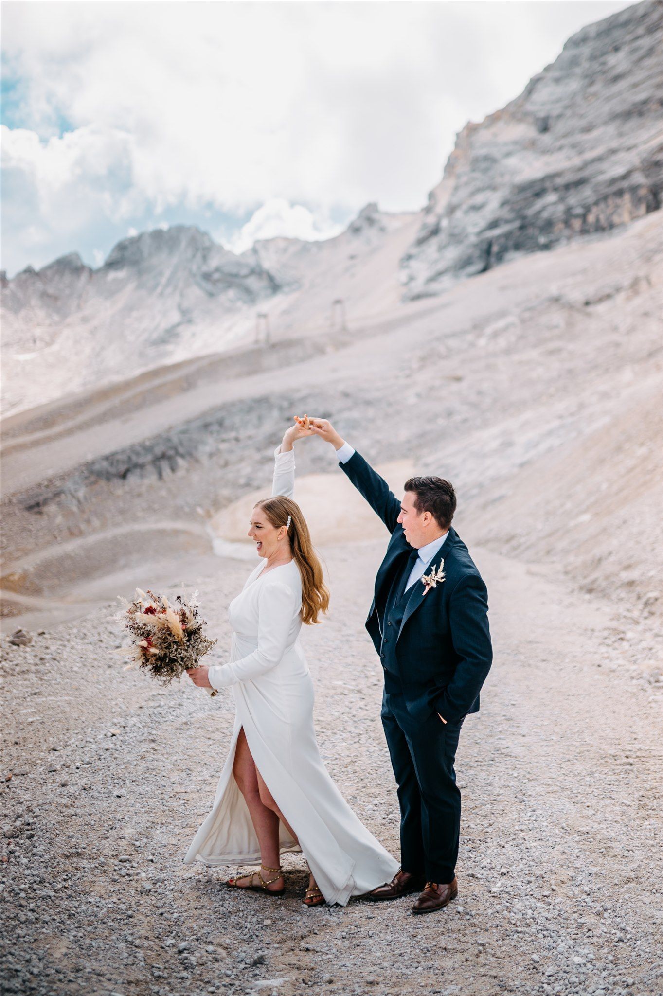 Bride and groom dancing on a mountain in the Bavarian Alps in Germany