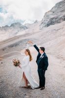 Bride and groom dancing on a mountain in the Bavarian Alps in Germany