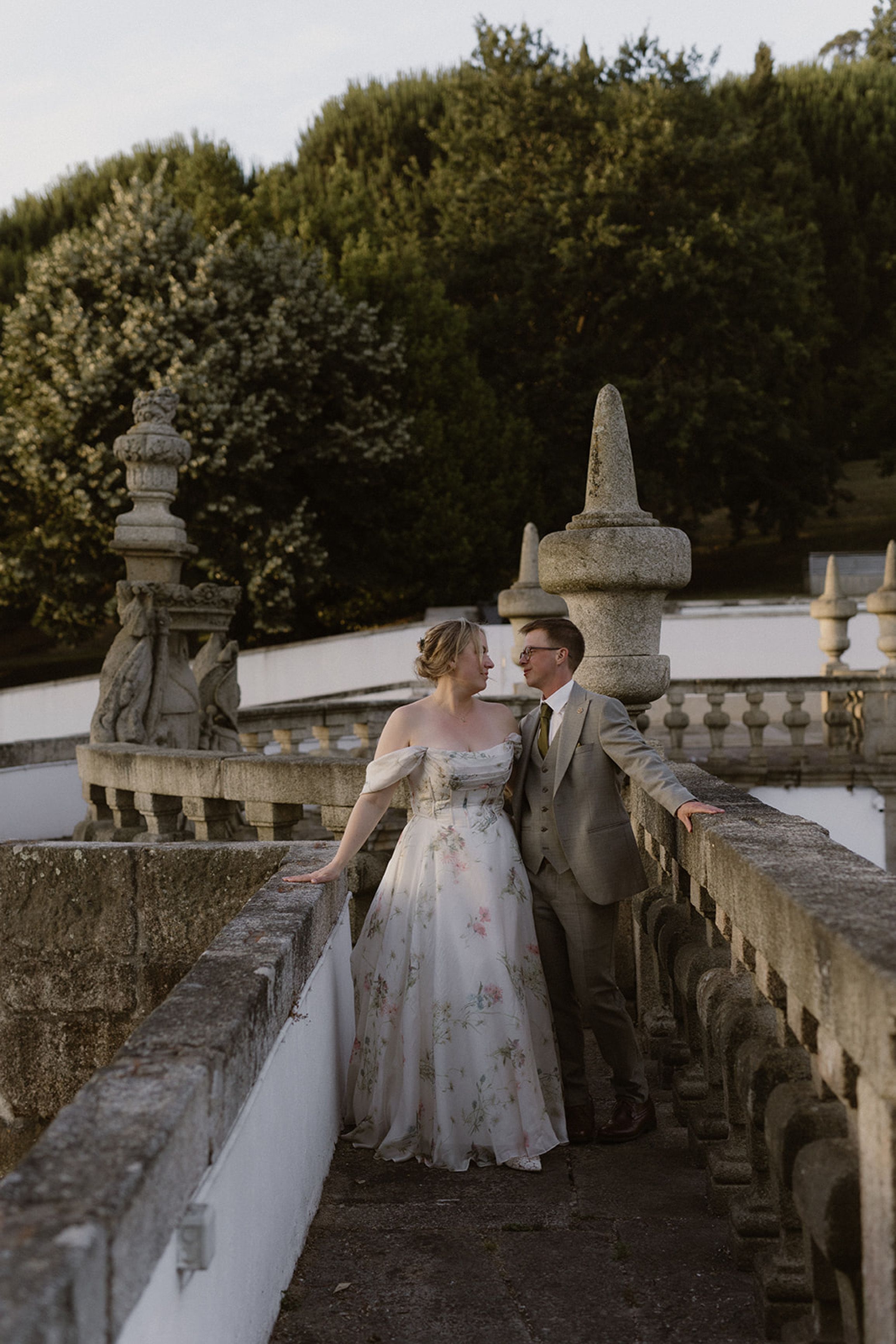 Bride and groom sharing a quiet moment on a stone terrace during a small wedding in Portugal