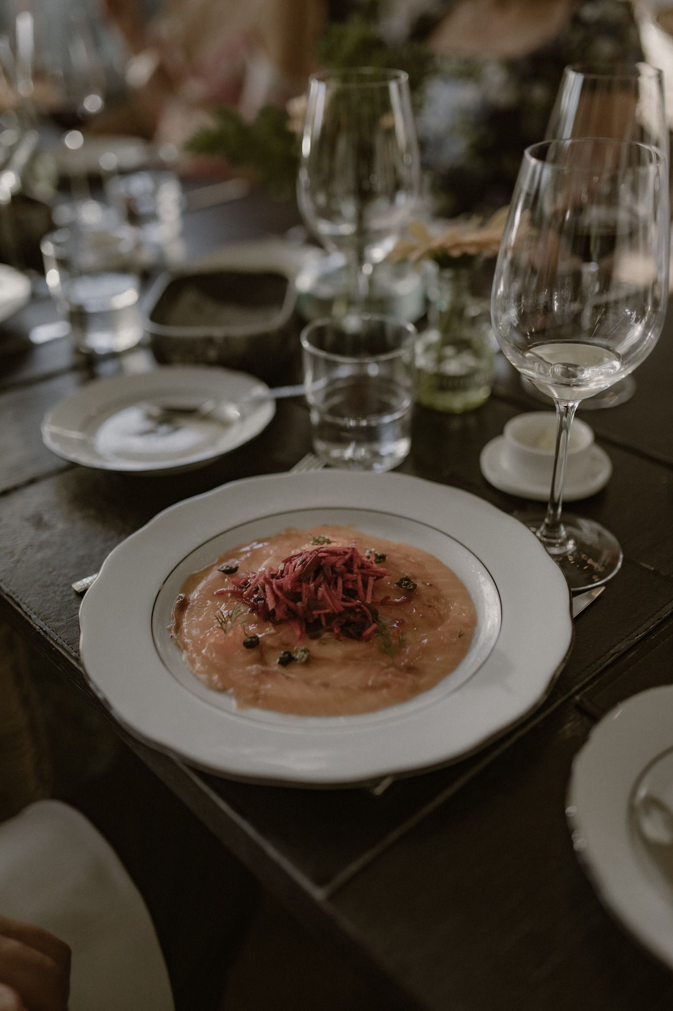 Seasonal starter served on white porcelain at a rustic wedding table