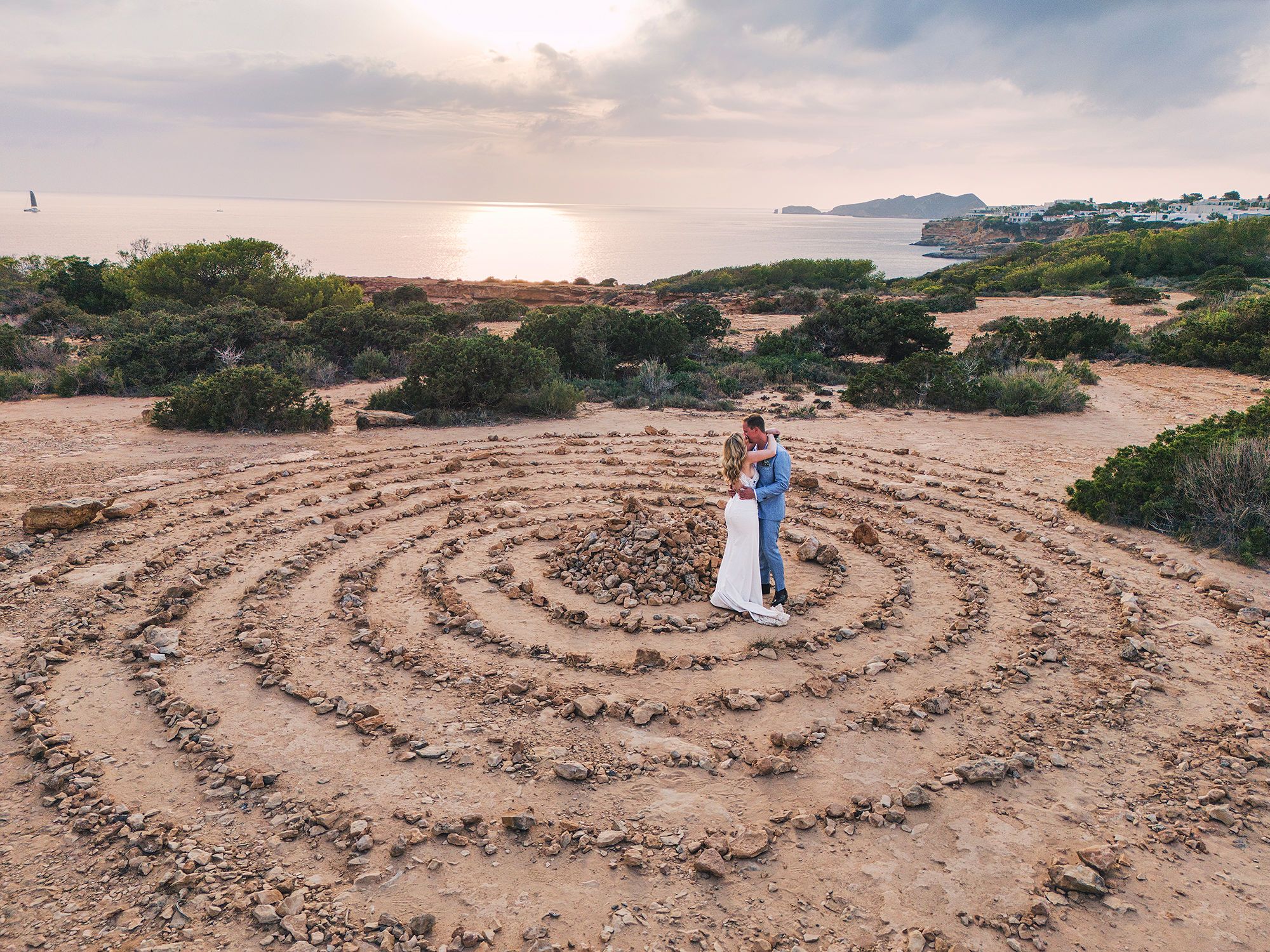Newlyweds having a photoshoot in the middle of Cala Llentia in Ibiza during their Spanish wedding abroad