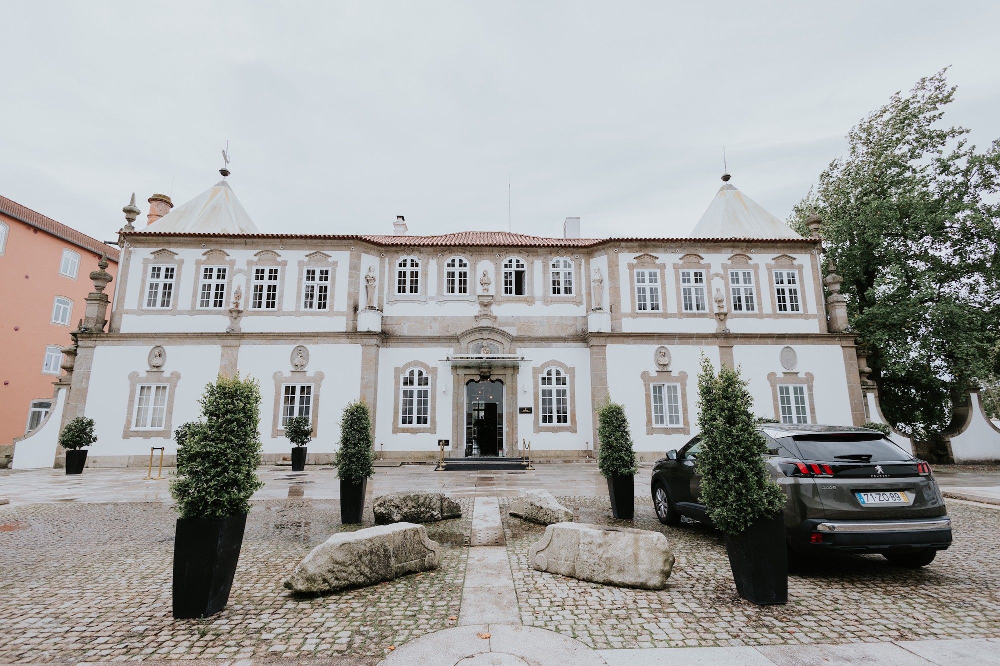 Facade of a palace with trees and a luxury car outside for destination weddings in Portugal