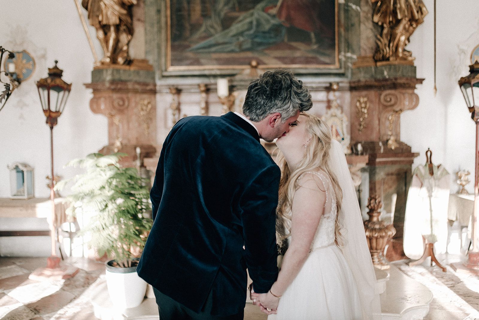 First kiss at the altar of a baroque chapel in Austria