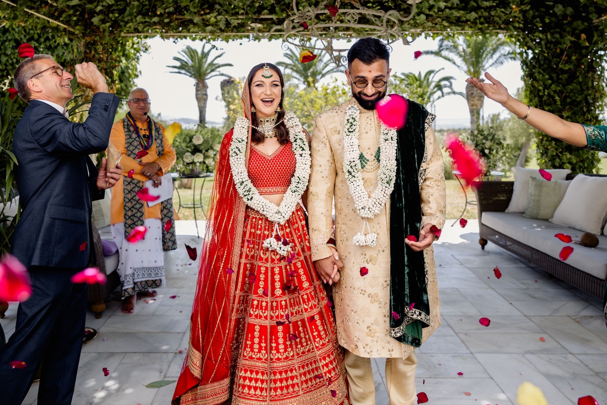 Bride and groom happily exit the ceremony area during their summer destination wedding in Spain at a farmhouse in Cadiz