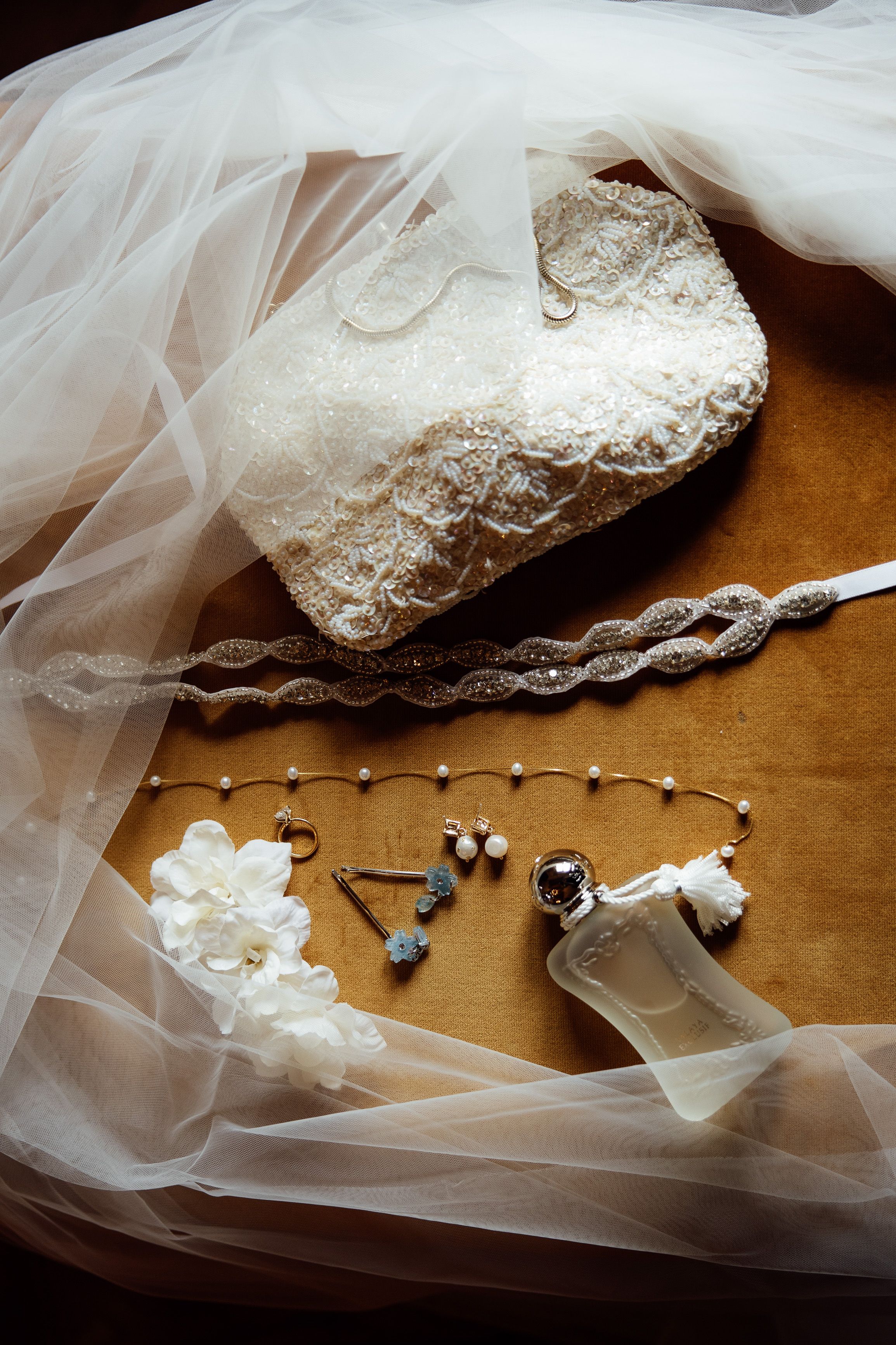 Bridal accessories, veil, perfume, and jewelry arranged for a small wedding in Austria