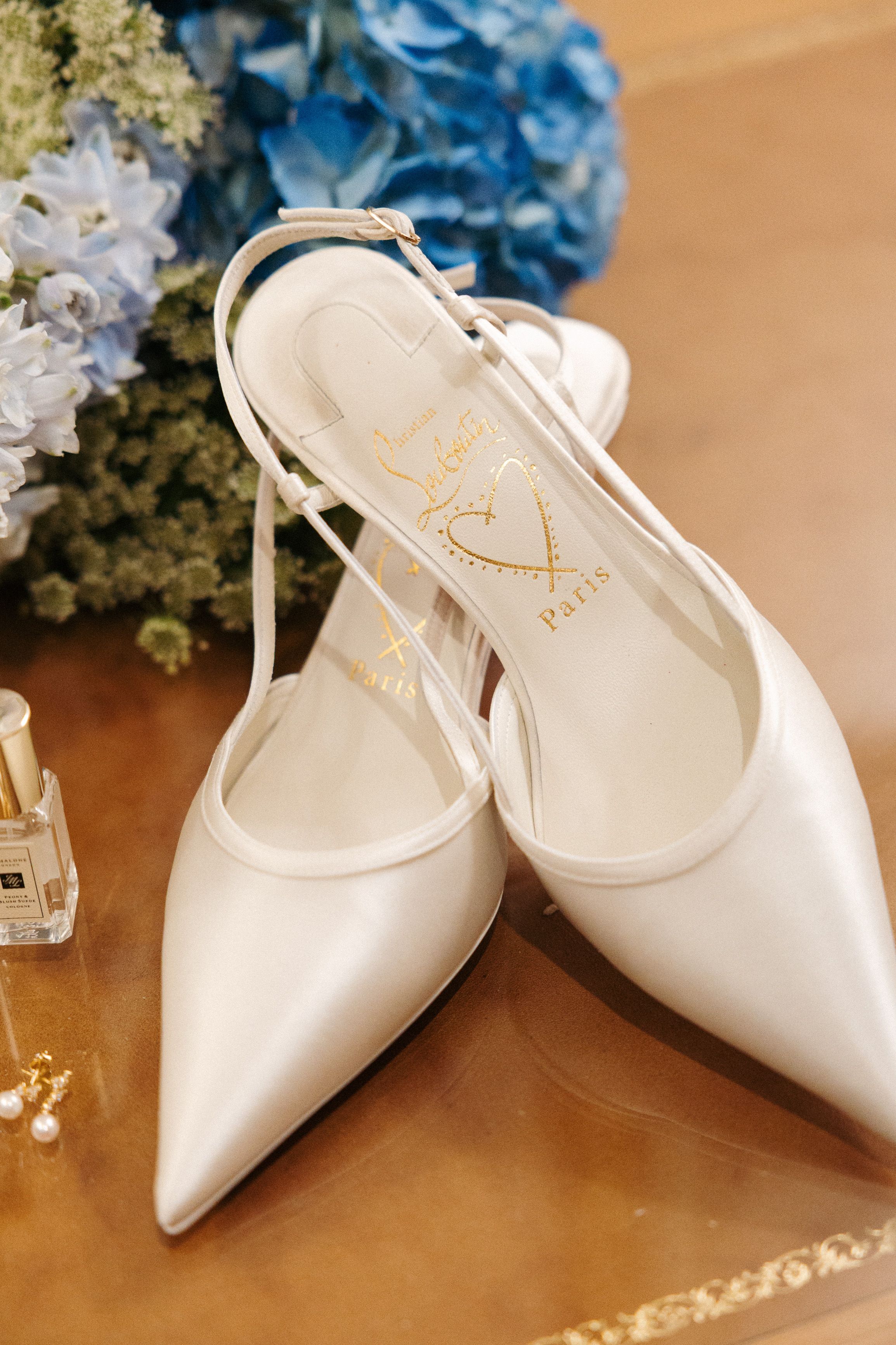 White bridal shoes styled with blue hydrangeas and wedding details for a small wedding in Portugal