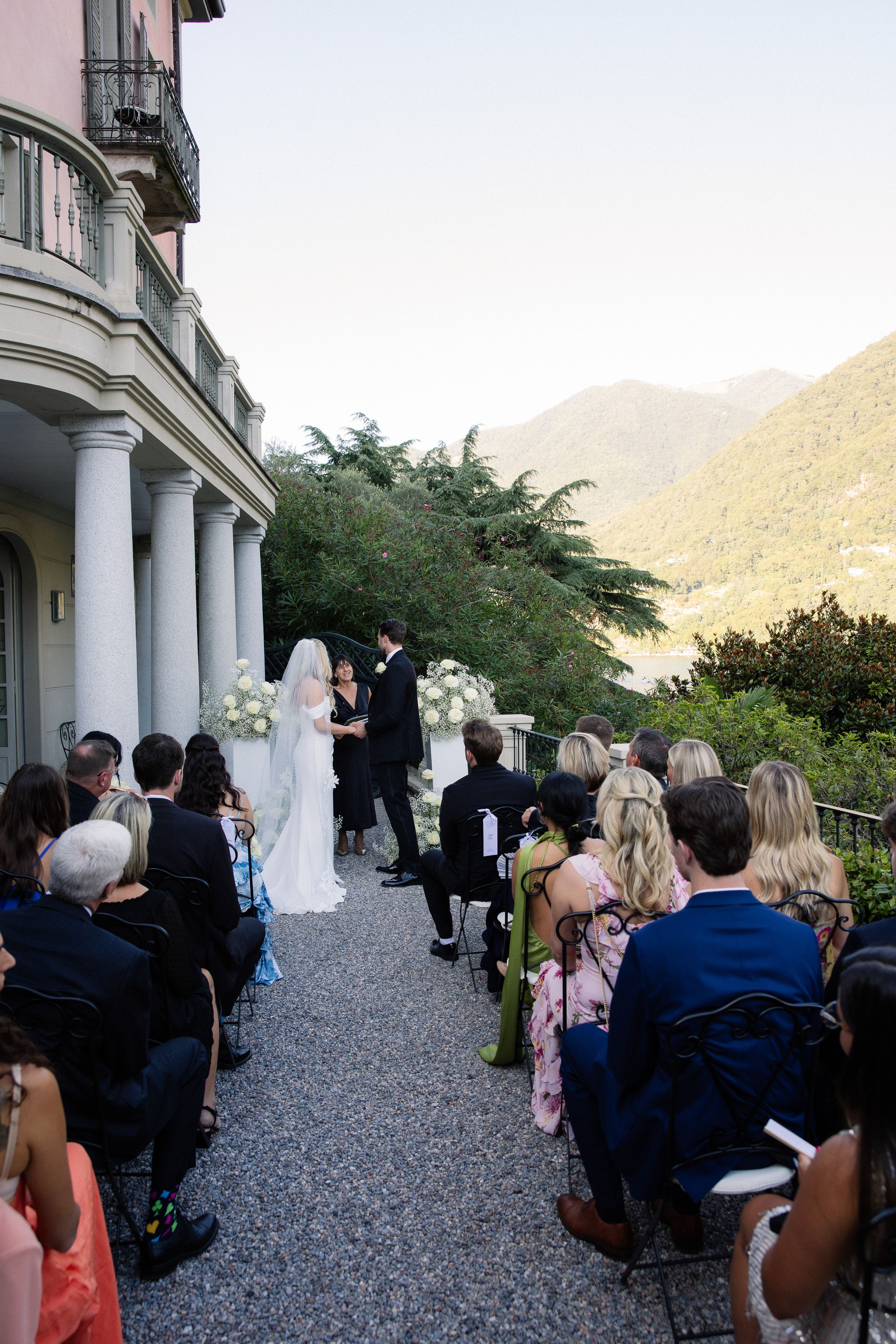 A bride and groom exchanging vows in front of their family and friends during their intimate wedding in Italy