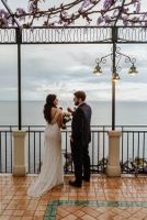 Bride and groom looking at each other at a terrace overlooking the Tyrrhenian Sea during thier elopement in Italy