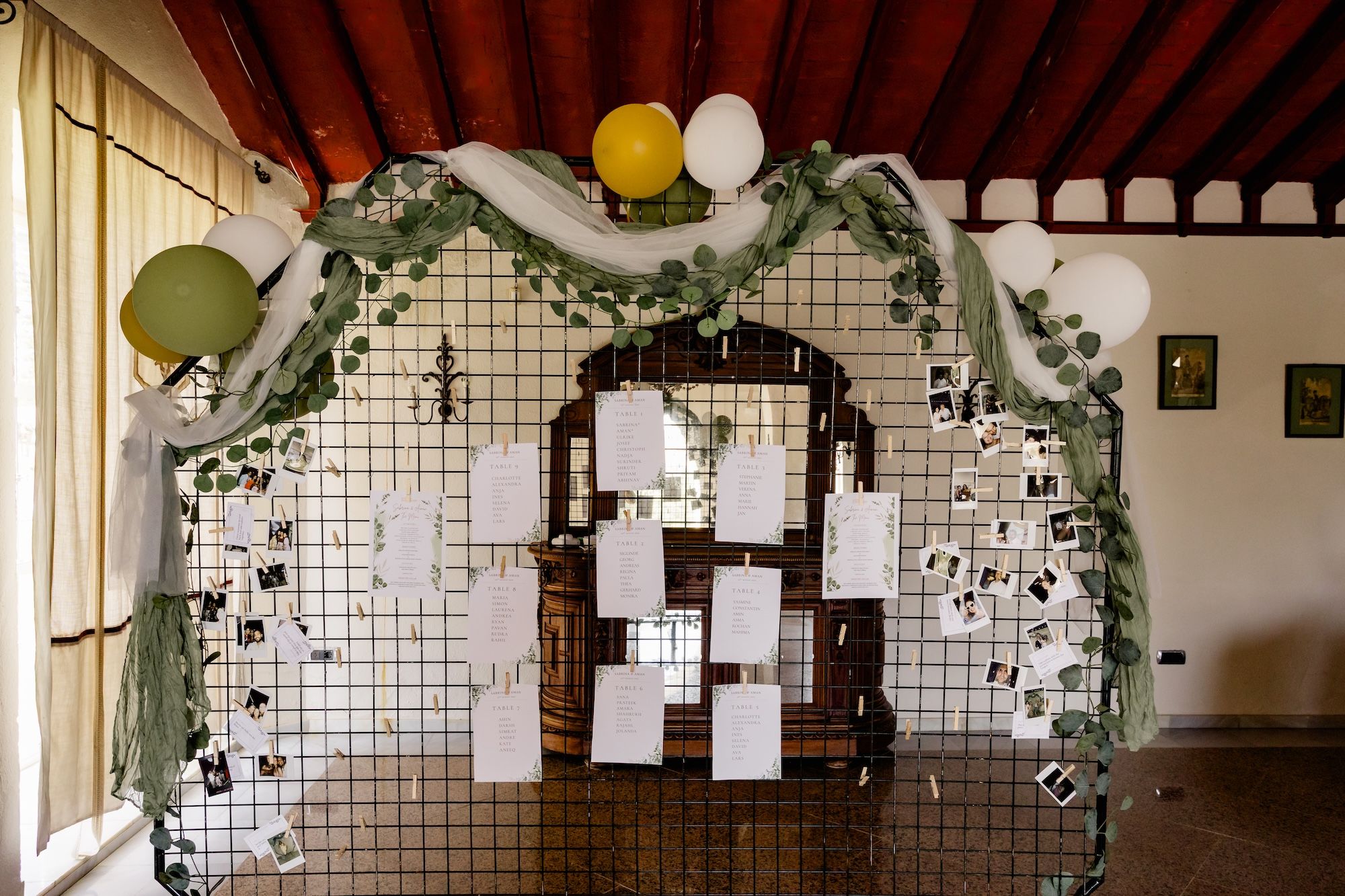 Details about a destination wedding in Spain written on stationaries and posted in an iron wall decor for the reception