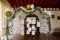 Details about a destination wedding in Spain written on stationaries and posted in an iron wall decor for the reception