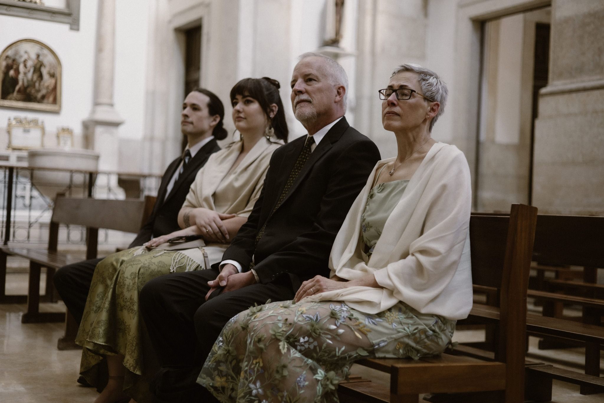 Family of a couple sitting in church during a wedding ceremony