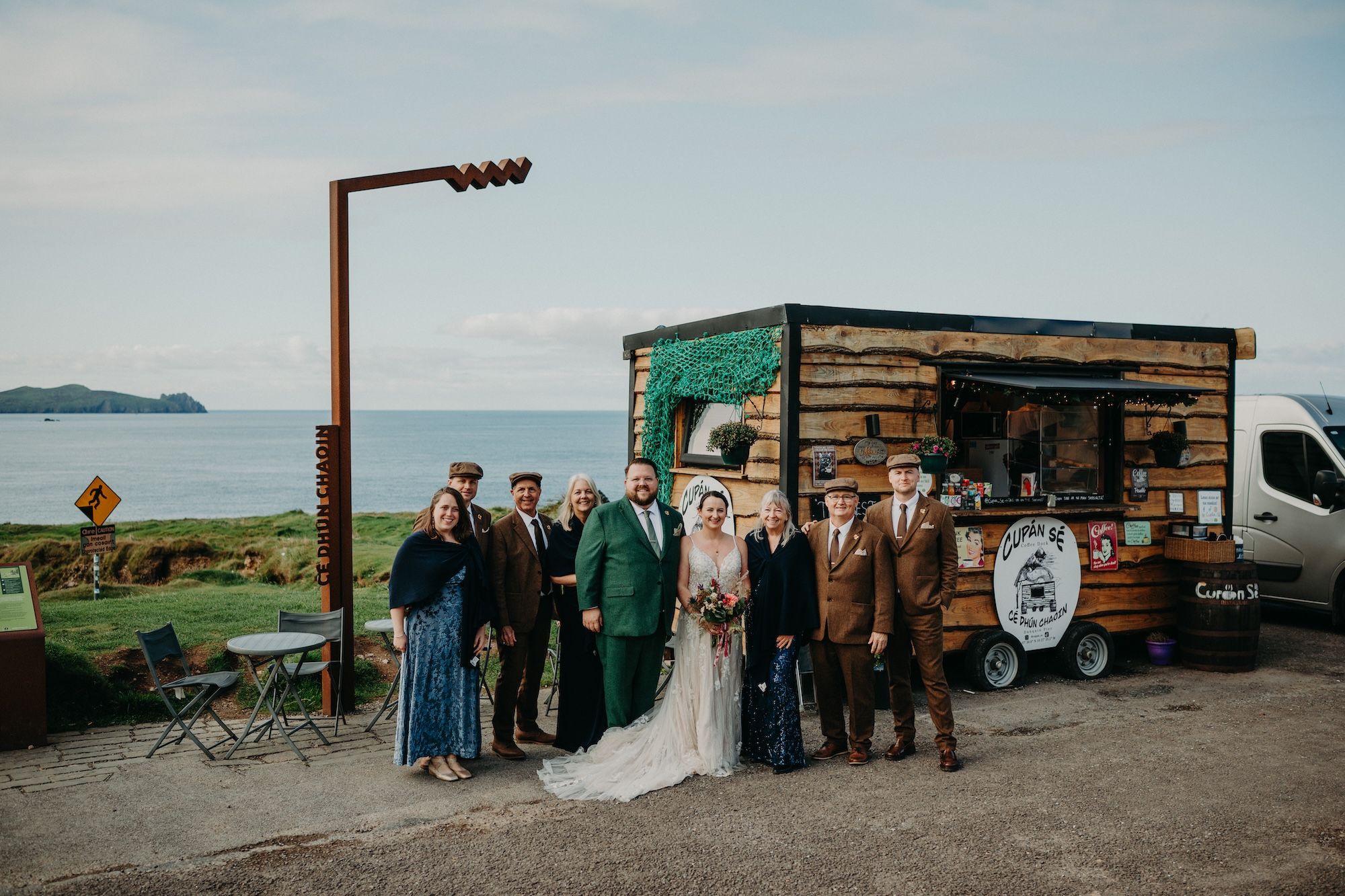Newlyweds with their guests at the Dunquin Pier during the photoshoot of their elopement in Ireland