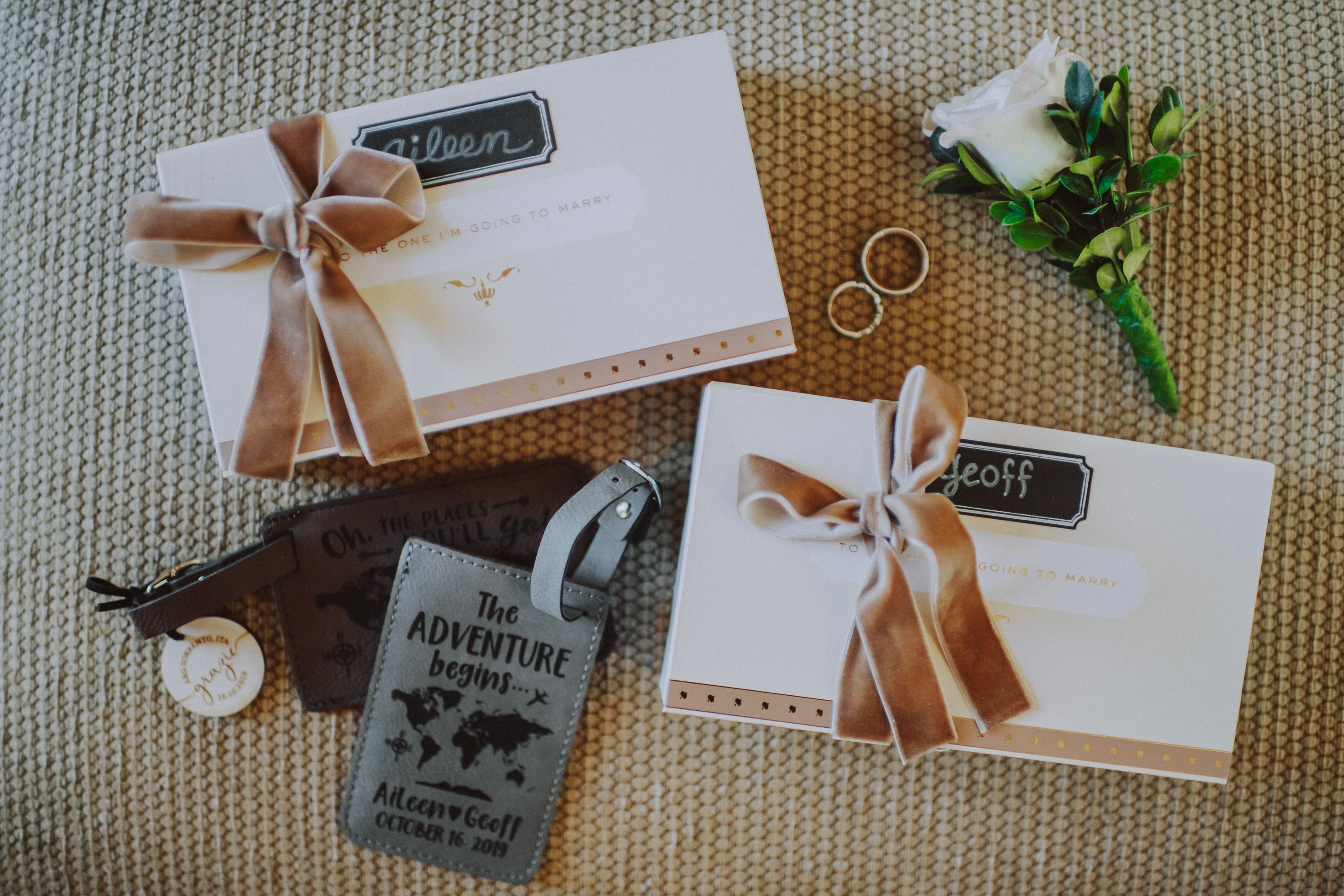 Personalized wedding gifts, rings and travel keepsakes prepared for guests at an intimate wedding in Italy