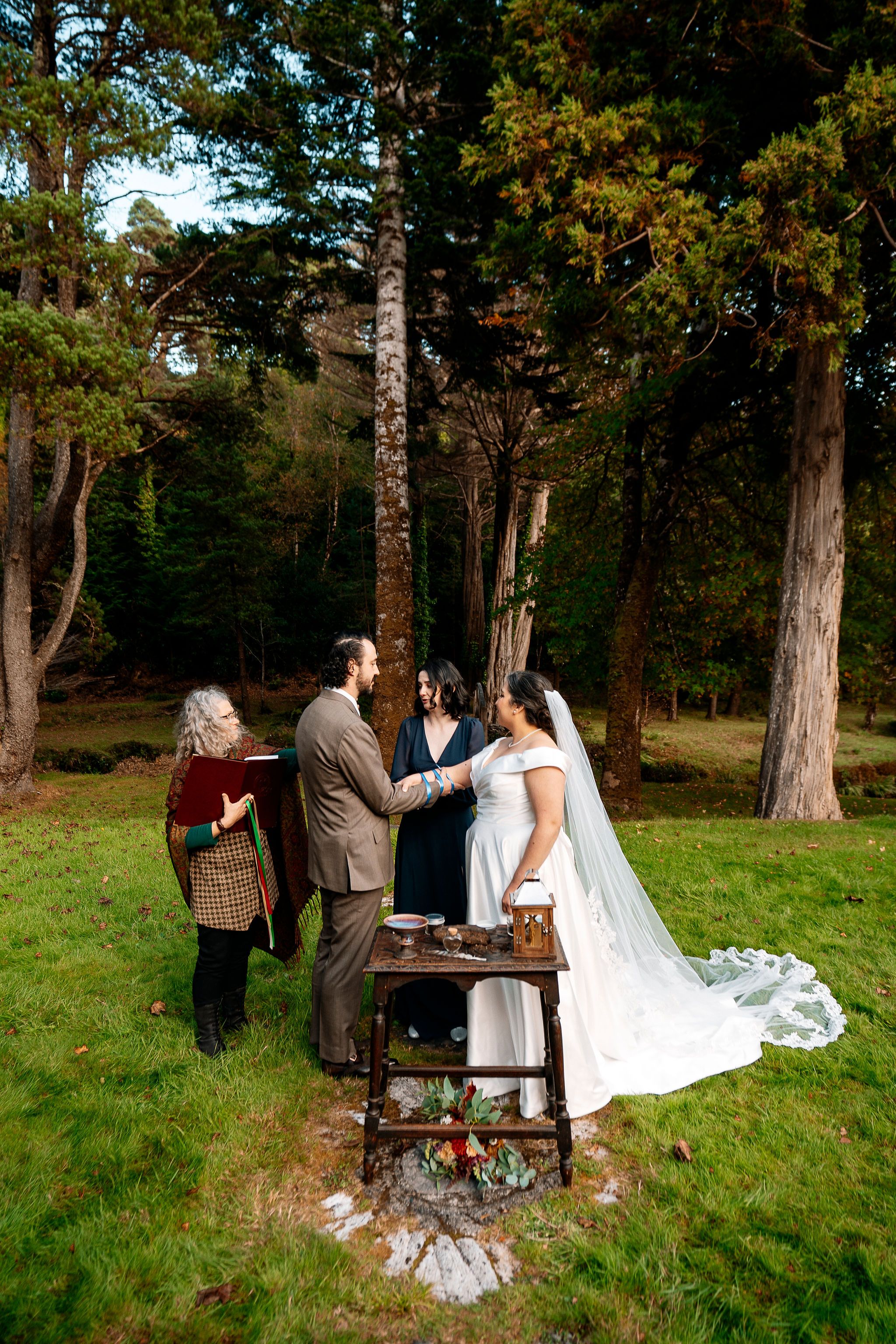Bride and groom holding hands while having a ceremony of their elopement in Ireland