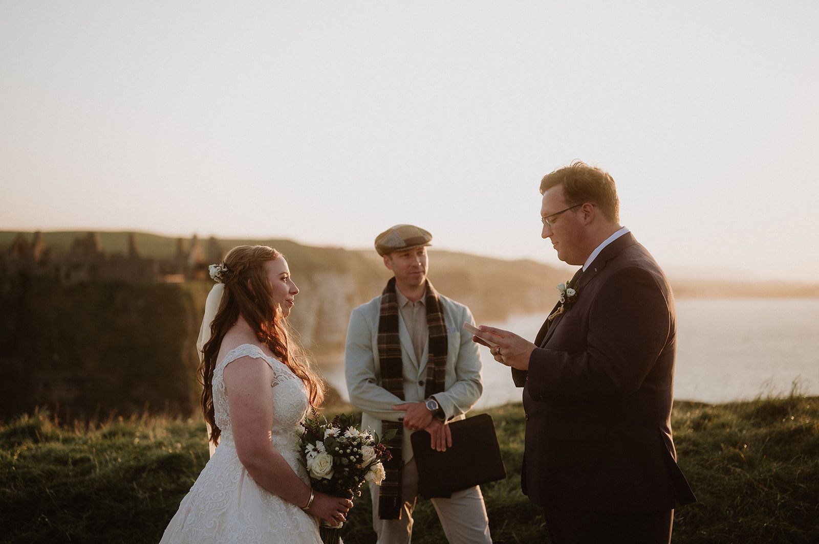 Bride and groom saying their vows in front of an officiant at their destination wedding in Northern Ireland