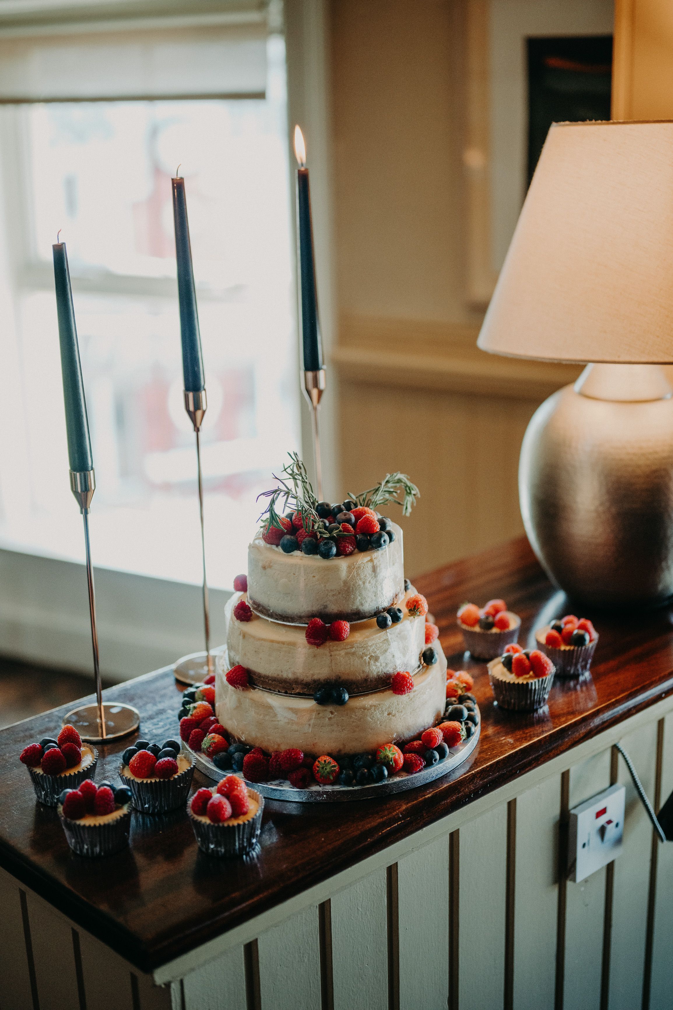A cake adorned with berries for a celebration set after a small wedding in Ireland
