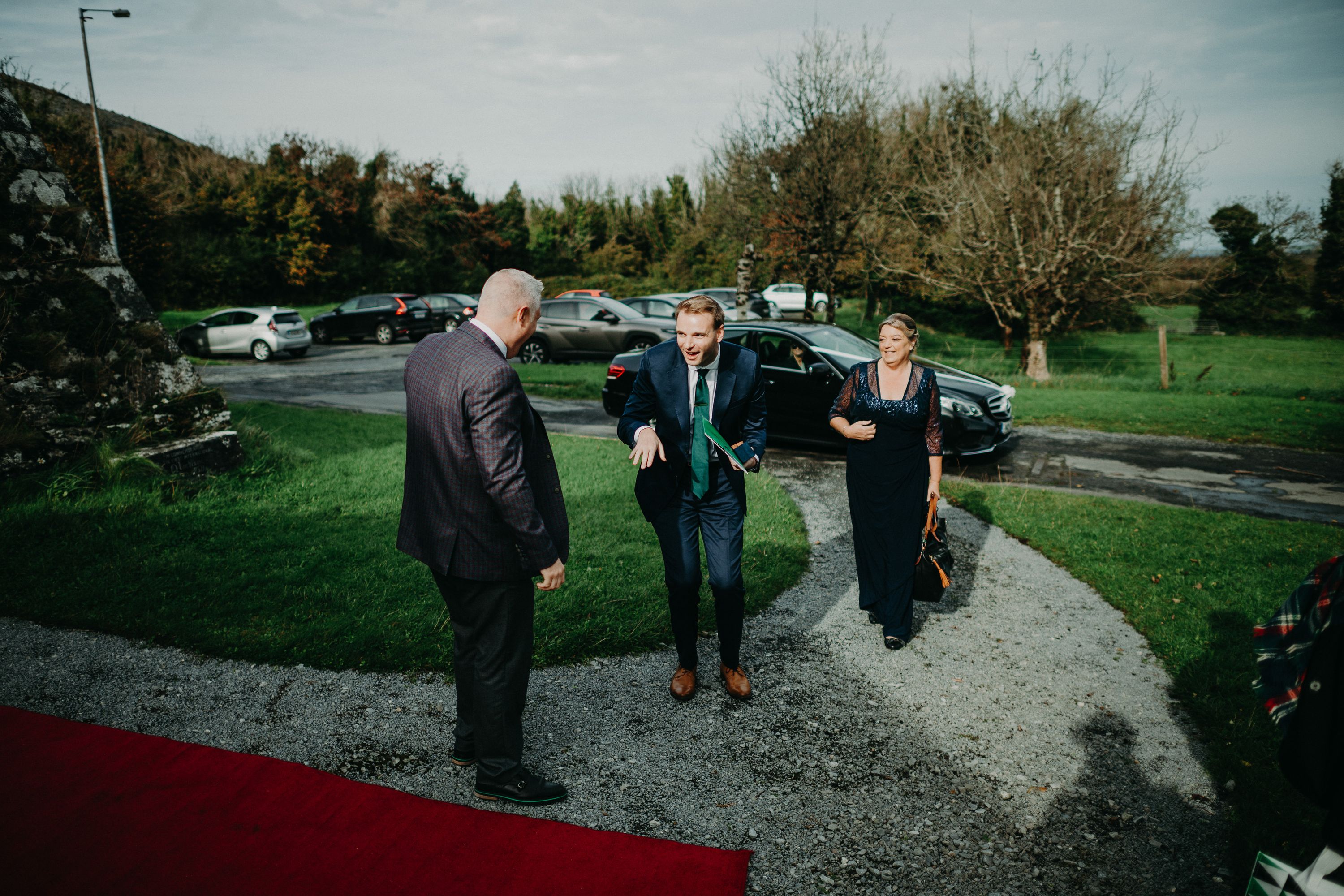 Groom arriving with family members before a small wedding in Ireland at a historic castle venue.
