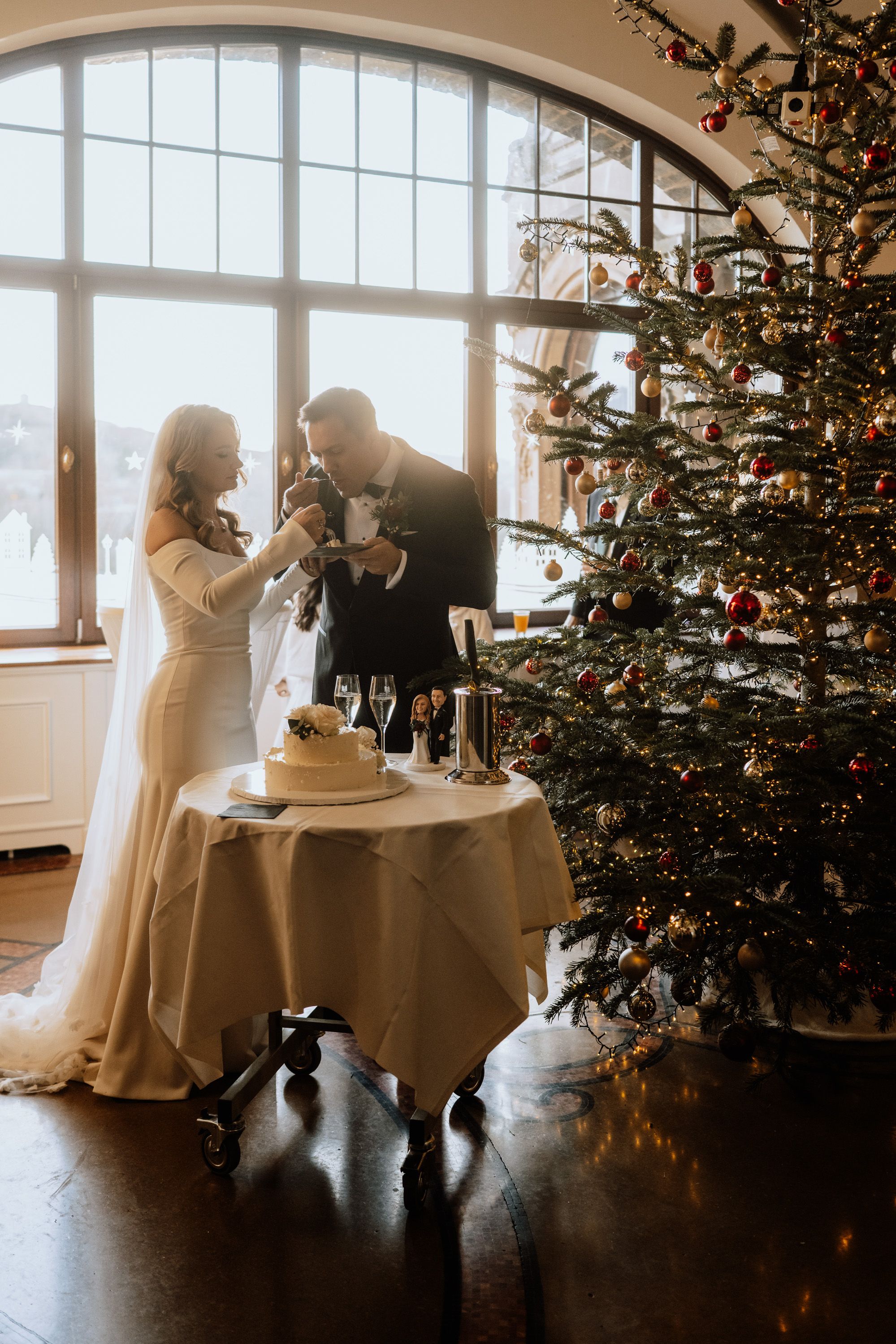 A bride and groom having cake during the reception of their intimate wedding in Germany