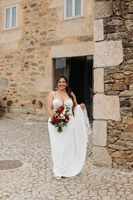 Bride happily walking on a cobbled ground before the ceremony of her intimate wedding in Portugal