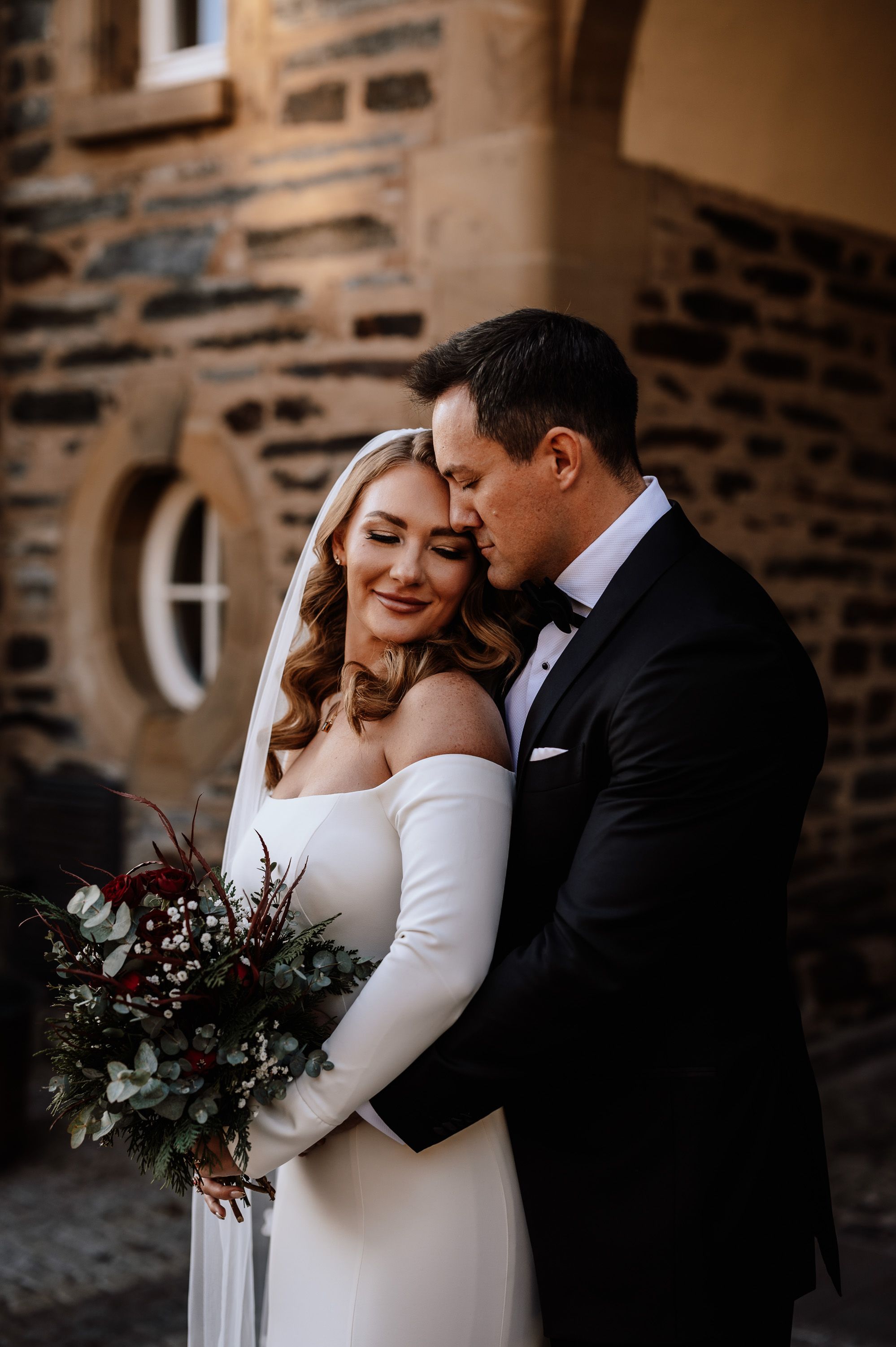 A groom hugging her bride during a pictorial for their intimate wedding in Germany