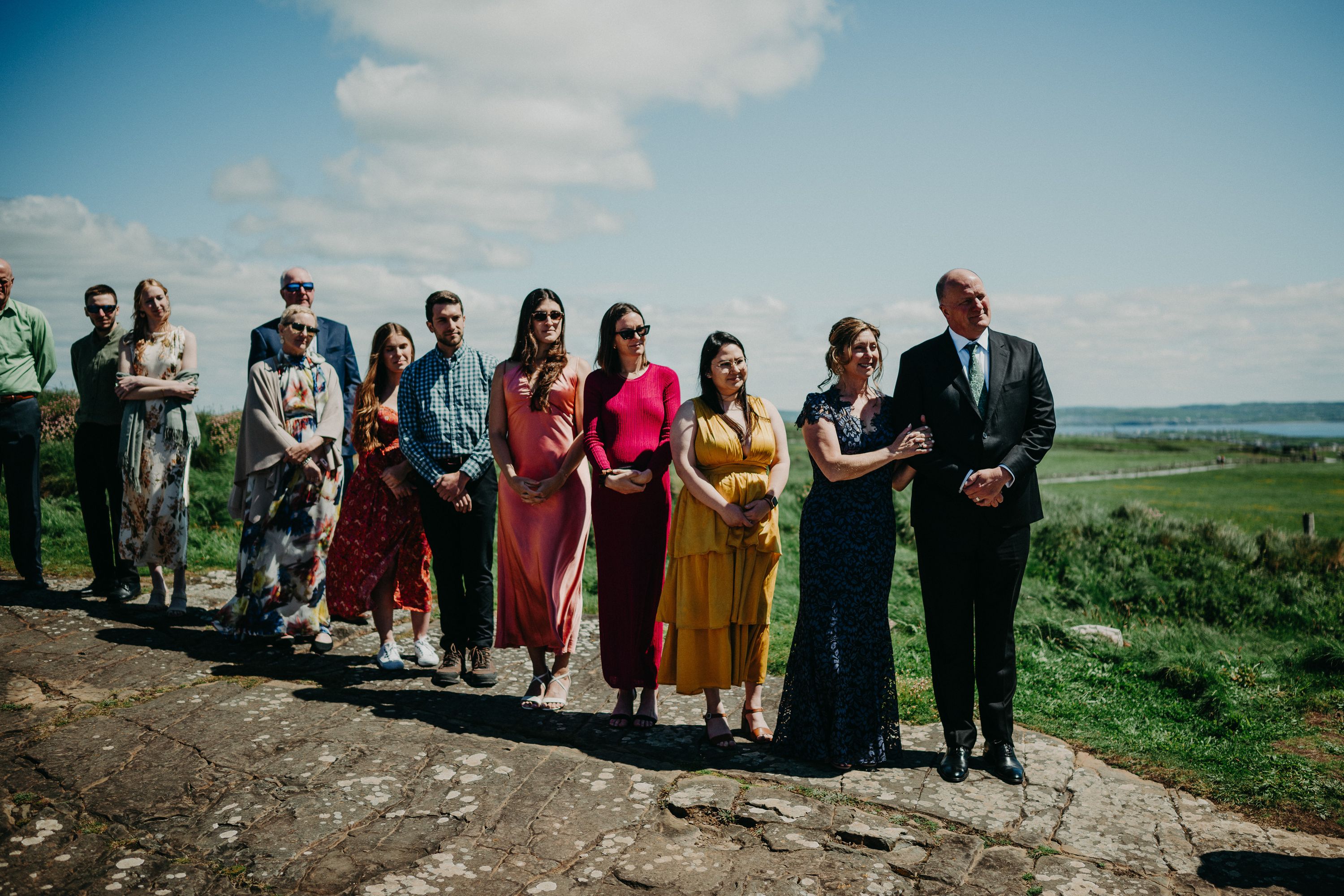 Friends and family of the couple wait for the bride and groom before their small wedding in Ireland
