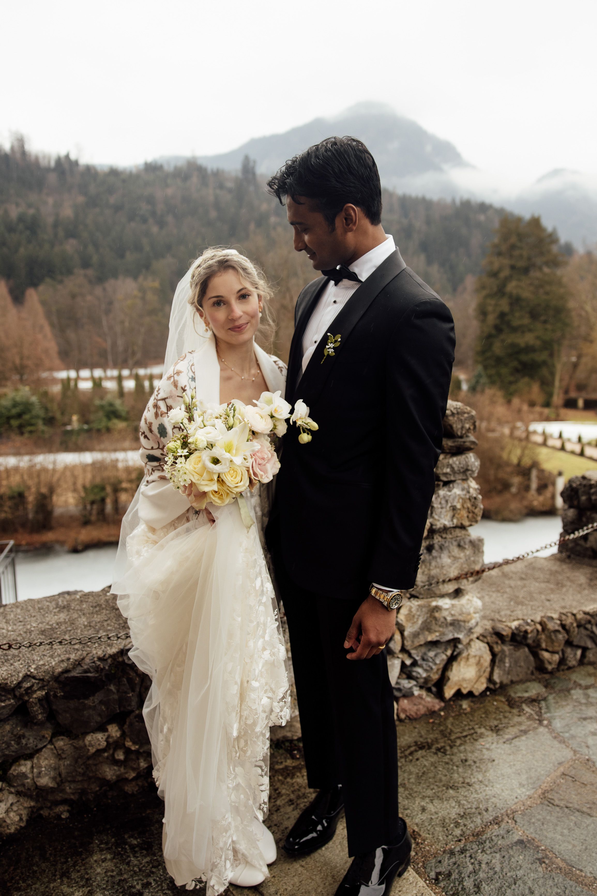 Bride and groom portrait with floral bouquet outside a castle at an intimate wedding in Austria
