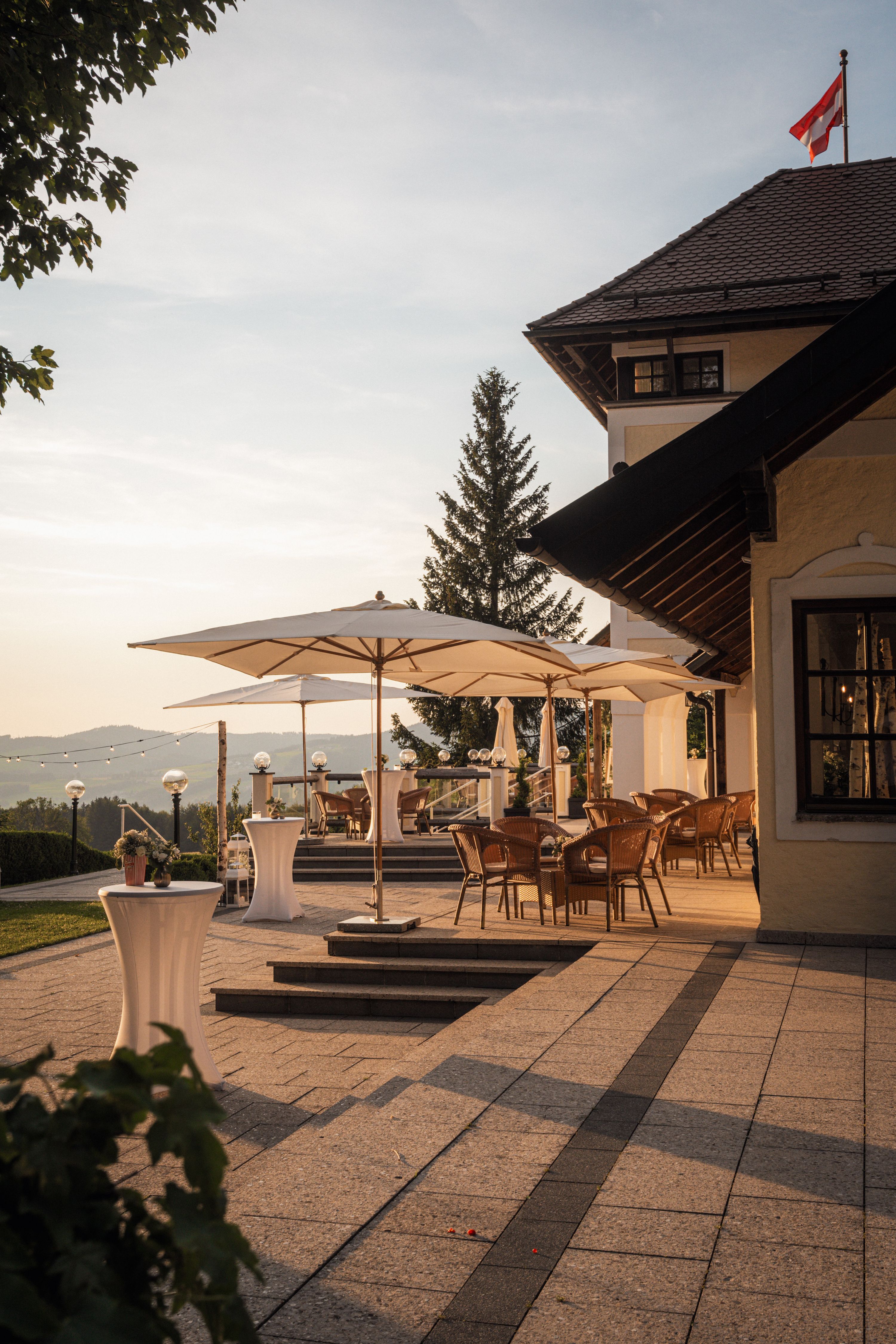 Sunset drinks on the terrace of a lakeside villa flying the Austrian flag