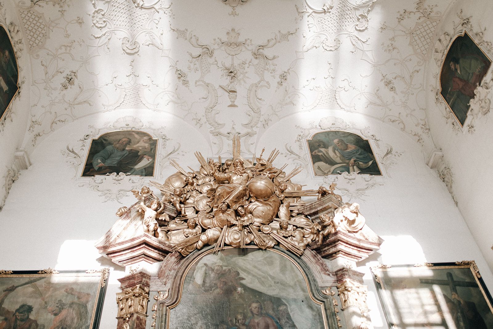 Gilded baroque chapel with stucco ceiling and ceiling paintings at an Austrian palace
