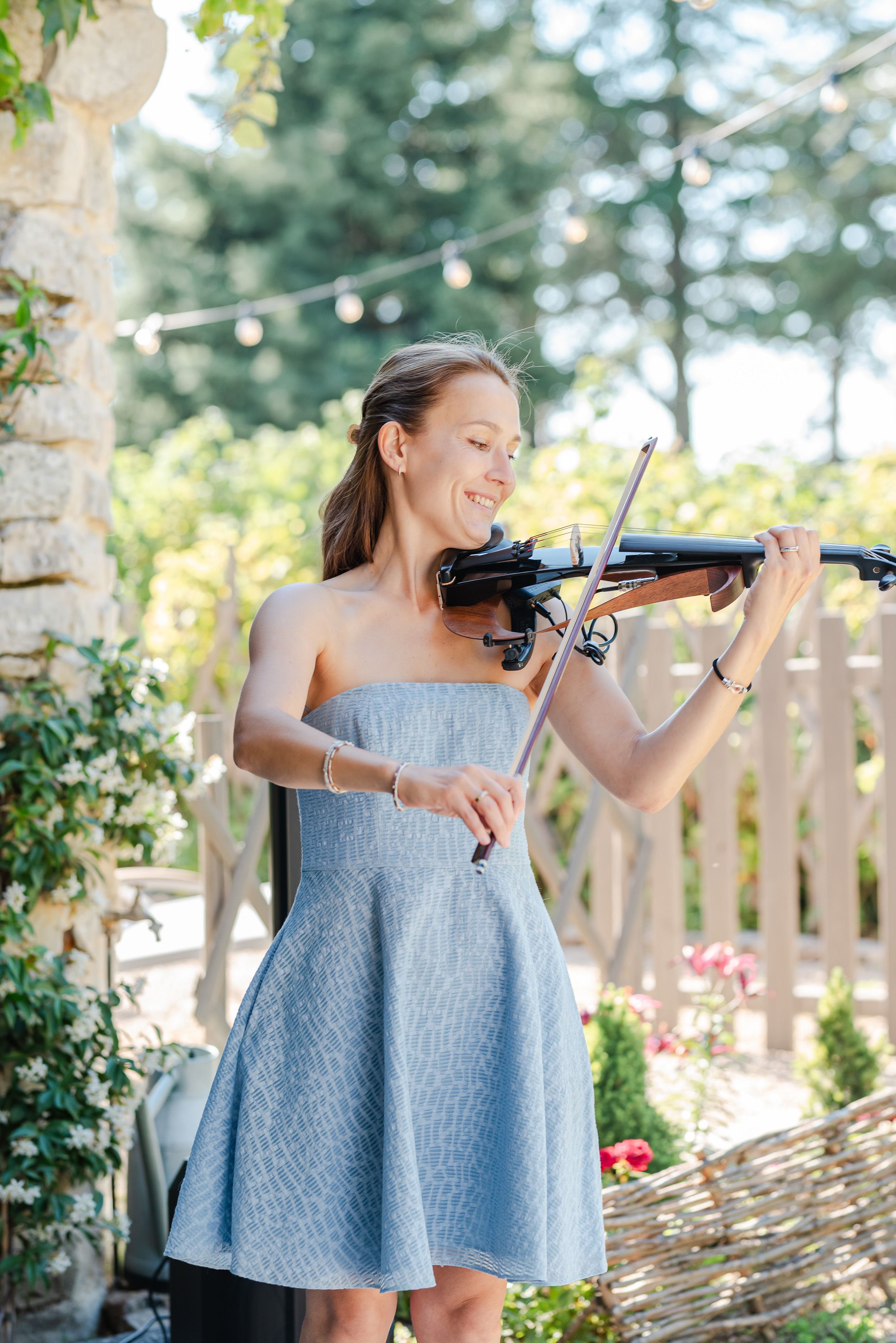 Violinist performing live music for guests at an intimate wedding in France