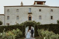 A Tuscan country estate with a medieval facade, surrounded by greenery