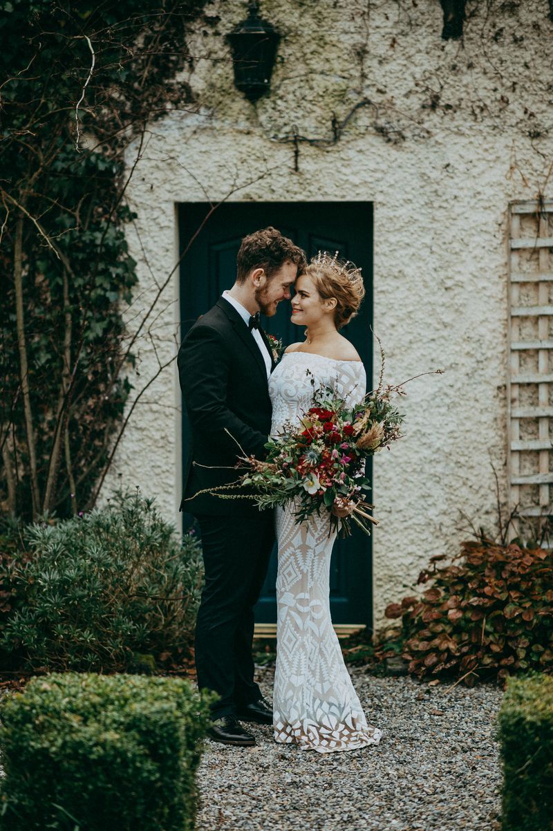 Bride and groom with foreheads next to each other having a photoshoot outdoors during their elopement in Ireland