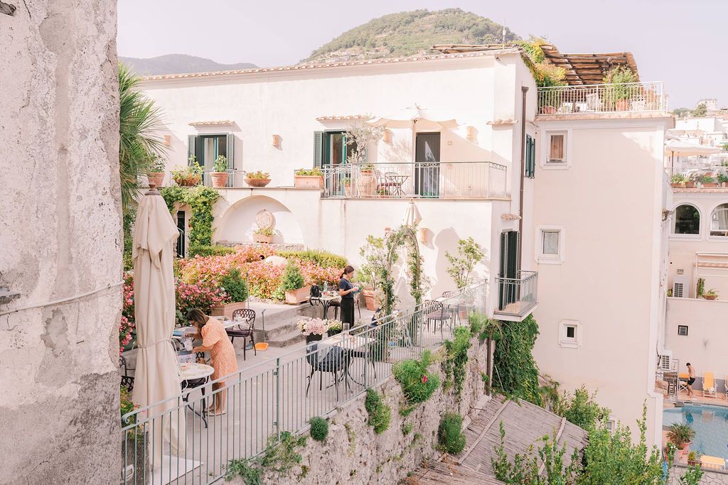 Antique hotel with vibrant gardens and a mountain backdrop in Amalfi