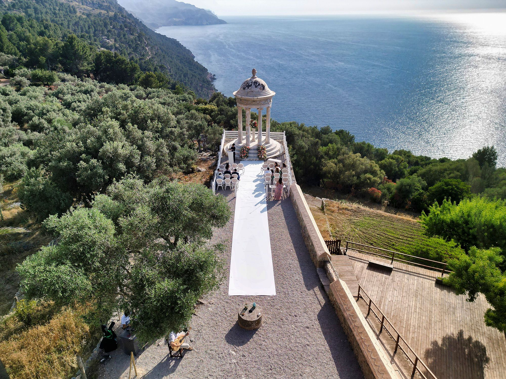 A ceremony takes place at a venue on the cliffs of Mallorca - an outdoor micro wedding in Spain