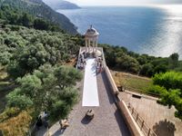 A ceremony takes place at a venue on the cliffs of Mallorca - an outdoor micro wedding in Spain