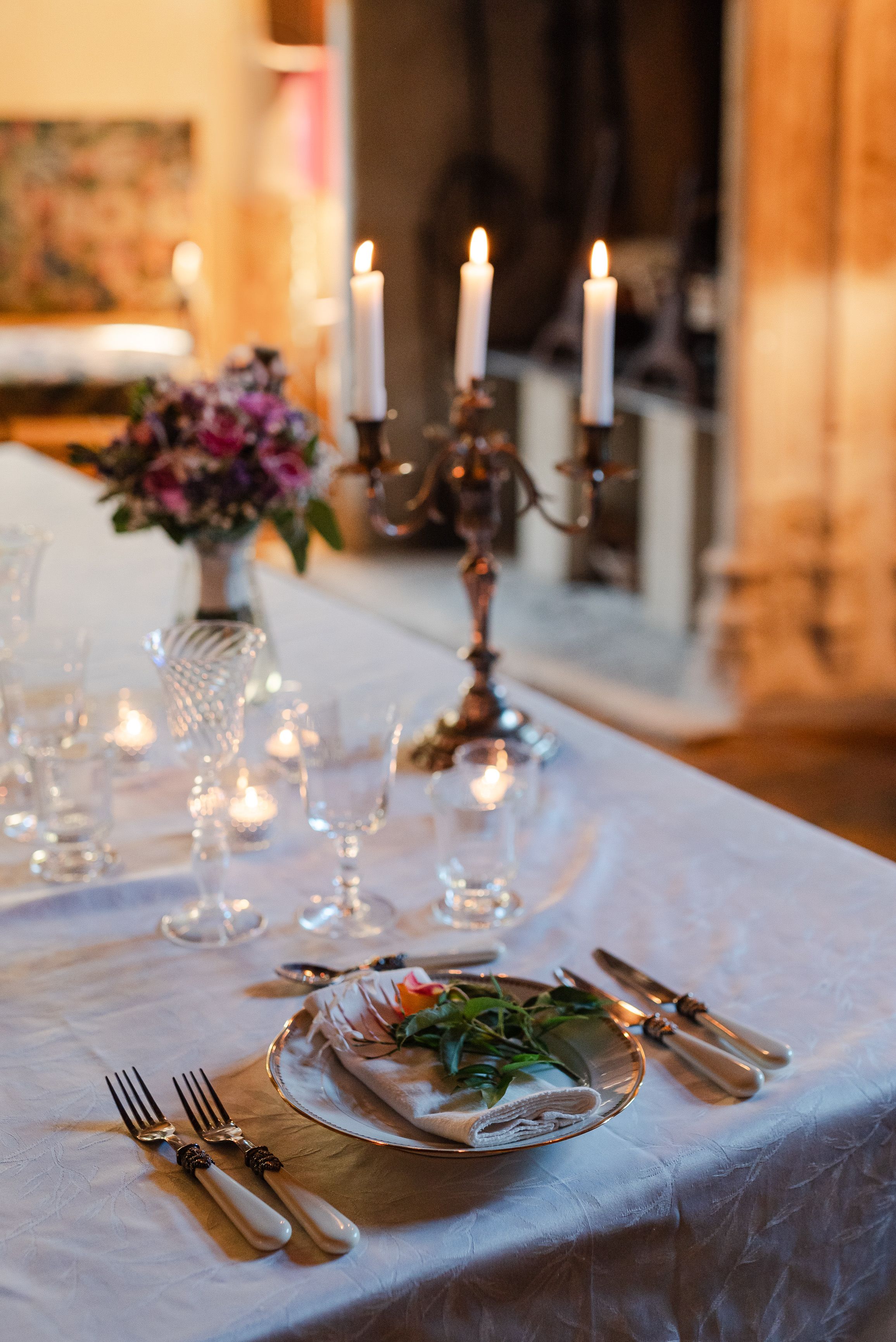 Candlelit wedding reception table with floral centerpiece for a small wedding in France