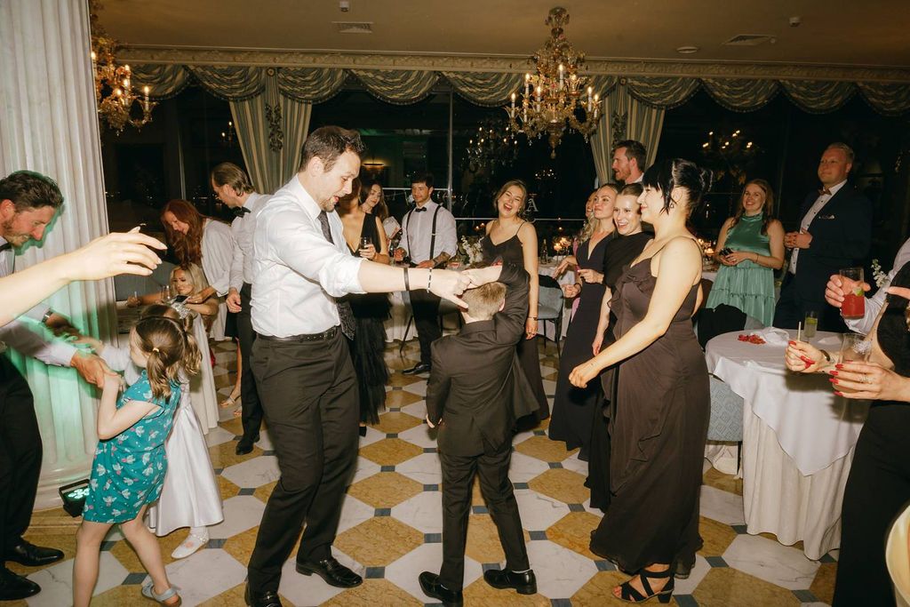 A groom  surrounded by guests at a small wedding in Italy