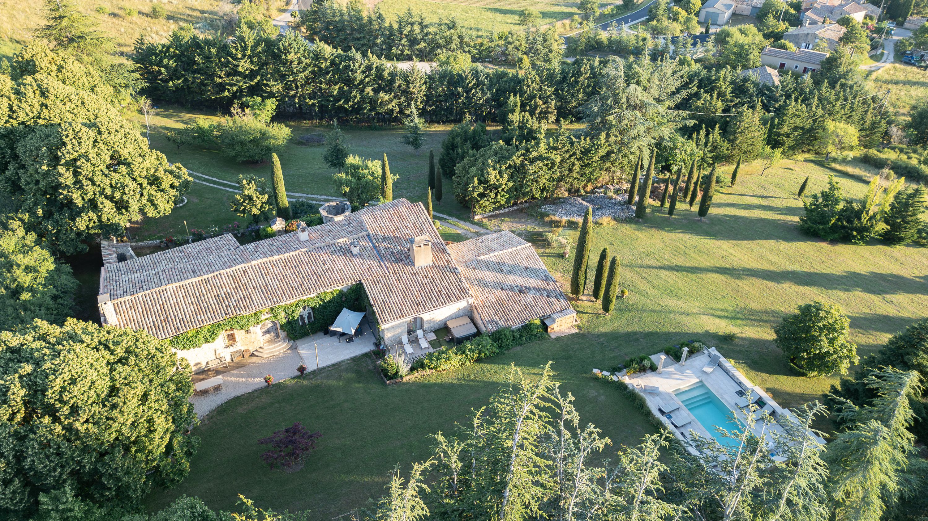 Aerial view of a countryside estate and gardens hosting an intimate wedding in France
