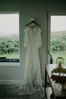 A long, off-shoulder white wedding dress for our bride who got married in Ireland