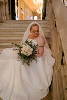 Bride holds her white and green minimalist bouquet during her vow renewal in Italy